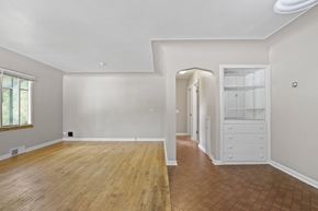 Denver apartment for rent - a living room with white walls and wooden floors and a white closet